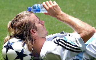 Real Madrid's English international David Beckham cools off at the end of a training session at the HK stadium in Hong Kong Thursday 07 August 2003. Real Madrid is in Hong Kong, as part of an Asia exhibition tour and will play against a joint China-Hong Kong team on 08 August 2003.
EPA PHOTO/EFE/PACO CAMPOS
 