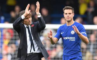 BRITAIN SOCCER ENGLISH PREMIER LEAGUE epa06280334 Chelsea's manager Antonio Conte (L) and player Cesar Azpilicueta greet supporters at the end of the English Premier League soccer match between Chelsea FC and Watford FC at Stamford Bridge in London, Britain, 21 October 2017. Chelsea won the match 4-2. EPA/FACUNDO ARRIZABALAGA EDITORIAL USE ONLY. No use with unauthorized audio, video, data, fixture lists, club/league logos or 'live' services. Online in-match use limited to 75 images, no video emulation. No use in betting, games or single club/league/player publications.