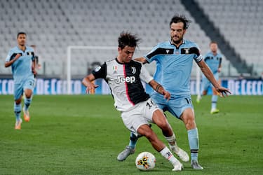 TURIN, ITALY - JULY 20: (L-R) Paulo Dybala of Juventus, Marco Parolo of Lazio  during the Italian Serie A   match between Juventus v Lazio at the Allianz Stadium on July 20, 2020 in Turin Italy (Photo by Mattia Ozbot/Soccrates/Getty Images)