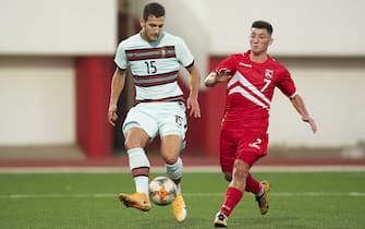 GIBRALTAR, GIBRALTAR - OCTOBER 13: Peacock of Gibraltar U21 competes for the ball with Diogo Dalot of Portugal U21 during the UEFA Euro Under 21 Qualifier match between Gibraltar U21 and Portugal U21 at Victoria Stadium on October 13, 2020 in Gibraltar, Gibraltar. (Photo by Mateo Villalba/Quality Sport Images/Getty Images)
