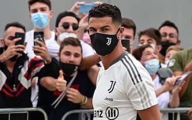 Juventus' Portuguese forward Cristiano Ronaldo is greeted by fans as he arrives for his medical examination at the club's Continassa training ground in Turin, on July 26, 2021. (Photo by MIGUEL MEDINA / AFP) (Photo by MIGUEL MEDINA/AFP via Getty Images)