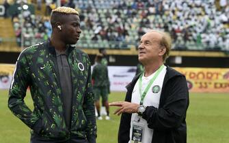 Nigeria's coach Gernot Rohr (R) speaks with Nigeria's striker Victor Osimhen before the FIFA Qatar 2022 World Cup qualification football match between Nigeria and Liberia at Teslim Balogun Stadium in Lagos, on September 3, 2021. (Photo by PIUS UTOMI EKPEI / AFP) (Photo by PIUS UTOMI EKPEI/AFP via Getty Images)