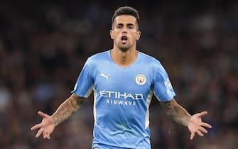 epa09470635 Manchester City's Joao Cancelo celebrates after scoring the 5-3 lead during the UEFA Champions League group A soccer match between Manchester City and RB Leipzig in Manchester, Britain, 15 September 2021.  EPA/Andrew Yates