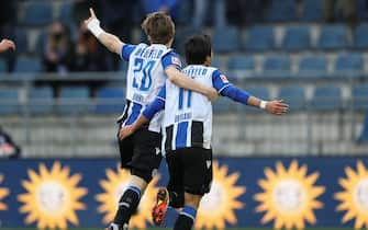 19 February 2022, North Rhine-Westphalia, Bielefeld: Soccer: Bundesliga, Arminia Bielefeld - 1. FC Union Berlin, Matchday 23 at Schüco Arena. Bielefeld's goal scorer Masaya Okugawa (r) celebrates his goal for 1:0 with Patrick Wimmer (l). Photo: Friso Gentsch/dpa - IMPORTANT NOTE: In accordance with the requirements of the DFL Deutsche Fußball Liga and the DFB Deutscher Fußball-Bund, it is prohibited to use or have used photographs taken in the stadium and/or of the match in the form of sequence pictures and/or video-like photo series.