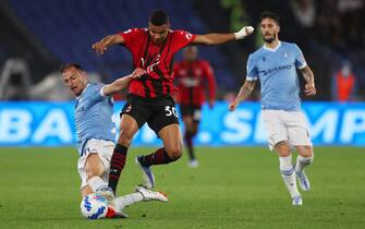 ROME, ITALY - APRIL 24: Junior Messias of AC Milan is challenged by Stefan Radu of SS Lazio during the Serie A match between SS Lazio and AC Milan at Stadio Olimpico on April 24, 2022 in Rome, Italy. (Photo by Paolo Bruno/Getty Images)
