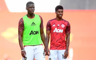 epa08506392 Paul Pogba (L) and Marcus Rashford of Manchester United during the warm-up before the English Premier League match between Manchester United and Sheffield United in Manchester, Britain, 24 June 2020.  EPA/Michael Regan/NMC/Pool EDITORIAL USE ONLY. No use with unauthorized audio, video, data, fixture lists, club/league logos or 'live' services. Online in-match use limited to 120 images, no video emulation. No use in betting, games or single club/league/player publications.