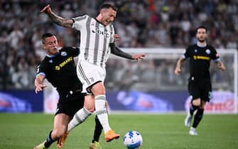 Juventus midfielder Federico Bernardeschi of Italy (C) vies for the ball with Lazios defender Adam Marusic from Italy during the Italian Serie A football match Juventus vs Lazio on May 16, 2022 at the Allianz Stadium in Turin. (Photo by MARCO BERTORELLO / AFP) (Photo by MARCO BERTORELLO/AFP via Getty Images)