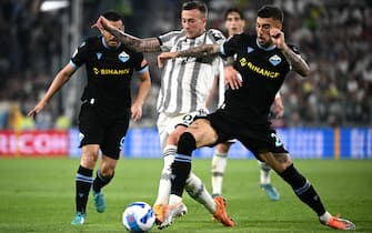 Juventus midfielder Federico Bernardeschi of Italy (C) vies for the ball with Lazios defender Manuel Lazzari from Italy during the Serie A football match Juventus vs Lazio at the Allianz Stadium in Turin on May 16, 2022. (Photo by MARCO BERTORELLO / AFP) (Photo by MARCO BERTORELLO/AFP via Getty Images)