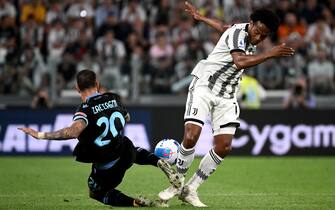 Lazios midfielder Mattia Zaccagni from Italy (L) fights for the ball with Juventus Colombian midfielder Juan Cuadrado during the Italian Serie A football match Juventus vs Lazio on May 16, 2022 at the Allianz Stadium in Turin. (Photo by MARCO BERTORELLO / AFP) (Photo by MARCO BERTORELLO/AFP via Getty Images)