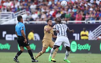 DALLAS, TX - JULY 26: Eric Garcia #24 of Barcelona and Moise Kean #18 of Juventus FC battle for the ball during the preseason friendly match between FC Barcelona and Juventus FC at Cotton Bowl on July 26, 2022 in Dallas, Texas. (Photo by Omar Vega/Getty Images)