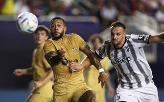 DALLAS, TX - JULY 26: Memphis Depay #9 of Barcelona and Federico Gatti #15 of Juventus FC battle for the ball during the preseason friendly match between FC Barcelona and Juventus FC at Cotton Bowl on July 26, 2022 in Dallas, Texas. (Photo by Omar Vega/Getty Images)