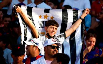 DALLAS, TEXAS - JULY 26: A fan of Juventus waves a flag before the match against FC Barcelona in an 2022 International Friendly match at the Cotton Bowl on July 26, 2022 in Dallas, Texas. (Photo by Ron Jenkins/Getty Images)