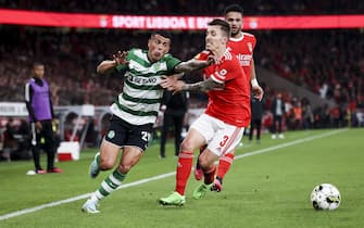 epa10407581 SL Benfica's player Alexandro Grimaldo (R) in action against Sporting CP player Pedro Porro (L) during the Portuguese Primeira Liga soccer match between SL Benfica and Sporting CP, in Lisbon, Portugal, 15 January 2023.  EPA/JOSE SENA GOULAO