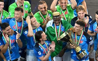 Napoli's Italian defender Giovanni Di Lorenzo (R) kisses the Italian Scudetto Championship trophy as he and his teammates celebrate winning the 2023 Scudetto championship title on June 4, 2023, following the Italian Serie A football match between Napoli and Sampdoria at the Diego-Maradona stadium in Naples. (Photo by Alberto PIZZOLI / AFP) (Photo by ALBERTO PIZZOLI/AFP via Getty Images)