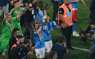 Napoli's Portuguese defender Mario Rui holds the Italian Scudetto Championship trophy as he and his teammates celebrate winning the 2023 Scudetto championship title on June 4, 2023, following the Italian Serie A football match between Napoli and Sampdoria at the Diego-Maradona stadium in Naples. (Photo by Tiziana FABI / AFP) (Photo by TIZIANA FABI/AFP via Getty Images)