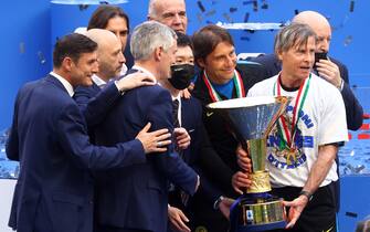 This file picture, dated 23 May 2021, shows Inter's head coach Antonio Conte who celebrates with owner and CEO of Fc Inter with the Scudetto trophy at the end of the Italian serie A soccer match between FC Inter and Udinese at Giuseppe Meazza stadium in Milan, Italy.   ANSA / MATTEO BAZZI