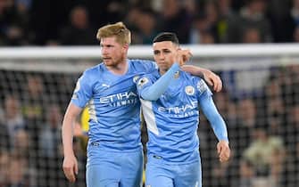 Manchester City's English midfielder Phil Foden celebrates with Manchester City's Belgian midfielder Kevin De Bruyne (L) after scoring his team second goal during the English Premier League football match between Manchester City and Brighton and Hove Albion at the Etihad Stadium in Manchester, north west England, on April 20, 2022. - RESTRICTED TO EDITORIAL USE. No use with unauthorized audio, video, data, fixture lists, club/league logos or 'live' services. Online in-match use limited to 120 images. An additional 40 images may be used in extra time. No video emulation. Social media in-match use limited to 120 images. An additional 40 images may be used in extra time. No use in betting publications, games or single club/league/player publications. (Photo by Oli SCARFF / AFP) / RESTRICTED TO EDITORIAL USE. No use with unauthorized audio, video, data, fixture lists, club/league logos or 'live' services. Online in-match use limited to 120 images. An additional 40 images may be used in extra time. No video emulation. Social media in-match use limited to 120 images. An additional 40 images may be used in extra time. No use in betting publications, games or single club/league/player publications. / RESTRICTED TO EDITORIAL USE. No use with unauthorized audio, video, data, fixture lists, club/league logos or 'live' services. Online in-match use limited to 120 images. An additional 40 images may be used in extra time. No video emulation. Social media in-match use limited to 120 images. An additional 40 images may be used in extra time. No use in betting publications, games or single club/league/player publications. (Photo by OLI SCARFF/AFP via Getty Images)