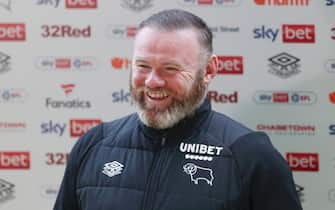 DERBY, ENGLAND - MAY 07: Wayne Rooney, Manager of Derby County smiles in a media interview after the Sky Bet Championship match between Derby County and Cardiff City at Pride Park Stadium on May 07, 2022 in Derby, England. (Photo by Cameron Smith/Getty Images)