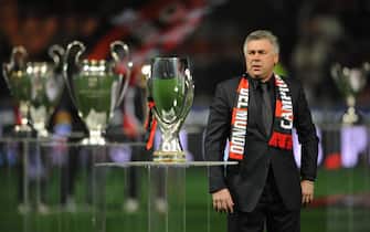 A.C. Milan's coach Carlo Ancelotti stands among of some of the 18 international tropies won by AC Milan, displayed on the pitch before an Italian serie A football match AC Milan vs Napoli at San Siro stadium in Milan, 13 January 2008.  AFP PHOTO / ALBERTO PIZZOLI (Photo credit should read ALBERTO PIZZOLI/AFP/Getty Images)
