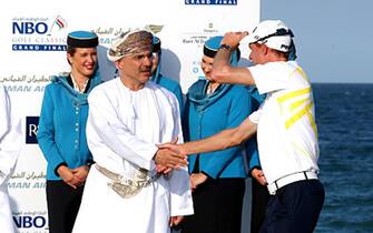 MUSCAT, OMAN - NOVEMBER 07:  (L_R)  David Williams, Chairman of The European, His Highness Sayyid Shihab Bin Tariq Al Said (R), Advisor to His Majesty The Sutlan Qaboos Bin Sai and Mr Mohammed bin Mafoodh Al Ardhi, Chairman of NBO congratulate Rhys Davies of ales of graduating to the European Tour after the final round of the NBO Golf Classic Grand Final at the Almouj Golf Club, The Wave on November 7, 2015 in Muscat, Oman.  (Photo by Warren Little/Getty Images)