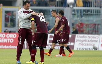 Livorno's defender Emerson (R) cries for the club's relegation in Serie B at the end of the Italian Serie A soccer match lost against ACF Fiorentina at Armando Picchi Stadium in Livorno, 11 May 2014. ANSA/ RICCARDO DALLE LUCHE 