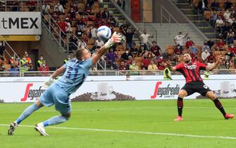 AC Milan's Olivier Giroud scores against Cagliari’s goalkeeper Boris Radunovic goal of 3 to 1 during the Italian serie A soccer match between AC Milan and Cagliari at Giuseppe Meazza stadium in Milan, 29 August 2021.ANSA / MATTEO BAZZI