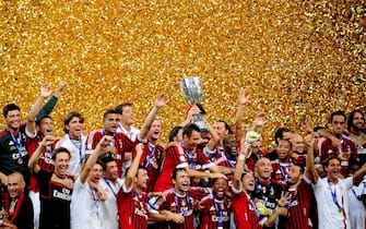 Football team players of AC Milan celebrate with the trophy after winning the Italian Super Cup 2011 match against Inter Milan at China's National Stadium, known as Bird's Nest, in Beijing on August 6, 2011. AC Milan beat Inter Milan 2-1. AFP PHOTO/Franko Lee (Photo credit should read Franko Lee/AFP via Getty Images)