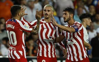 epa10146211 Atletico's players (L-R) Angel Correa, Antoine Griezmann and Koke Resurreccion celebrate at the end of the Spanish LaLiga soccer match between Valencia CF and Atletico Madrid held at Mestalla Stadium, in Valencia, eastern Spain, 29 August 2022.  EPA/Biel Alino