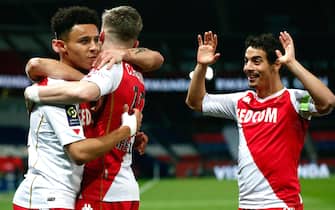 epa09028799 Sofiane Diop (L) of Monaco celebrates with teammates after scoring the opening goal during the French Ligue 1 soccer match between Paris Saint-Germain (PSG) and AS Monaco in Paris, France, 21 February 2021.  EPA/IAN LANGSDON