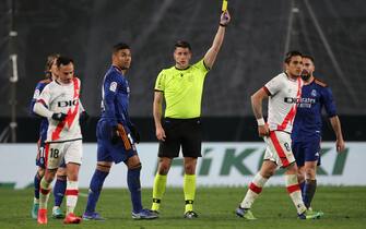 Oscar Trejo of Rayo Vallecano receives yellow card during the La Liga match between Rayo Vallecano v Real Madrid played at Vallecas Stadium on Feb 26, 2022 in Madrid, Spain. (Photo by Isabel Infantes / PRESSINPHOTO)