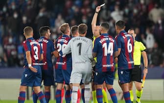 The referee Pablo Gonzalez Fuertes shows yellow card at full time during the La Liga match between Levante UD v Atletico de Madrid played at Ciutat Valencia Stadium on October 28, 2021 in Barcelona, Spain. (Photo by PRESSINPHOTO)