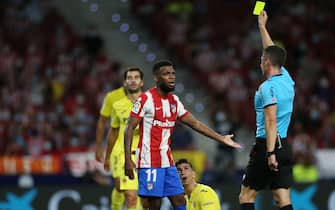 Thomas Lemar of Atletico de Madrid receives a yellow card during the La Liga match between Atletico de Madrid v Villarreal CF played at Wanda Metropolitano Stadium on August 22, 2021 in Madrid, Spain. (Photo by Isabel Infantes / PRESSINPHOTO)