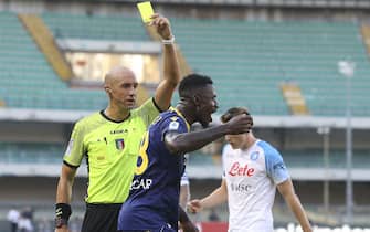 Referee Micheal Fabbri shows the yellow card to Martin Hongla of Hellas Verona FC during Hellas Verona vs SSC Napoli, 1Â° Serie A Tim 2022-23 game at Marcantonio Bentegodi Stadium in Verona, Italy, on August 15, 2022.