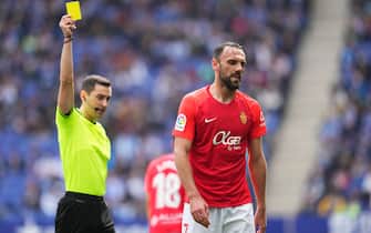 Vedat Muriqi of RCD Mallorca receives yellow card during the La Liga match between RCD Espanyol v RCD Mallorca played at RCDE Stadium on Mar 20, 2022 in Barcelona, Spain. (Photo by PRESSINPHOTO)