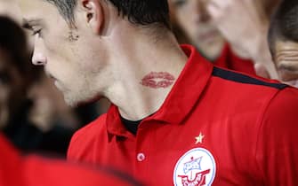 MUENSTER, GERMANY - OCTOBER 16:  Dennis Erdmann of Rostock with a kiss tattoo during the Third League match between Preussen Muenster and Hansa Rostock at Preussenstadion on October 16, 2015 in Muenster, Germany.  (Photo by Mika Volkmann/Bongarts/Getty Images)