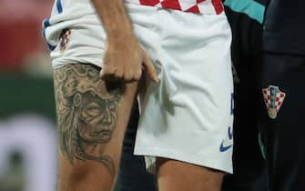 The tattoo of Croatia's defender Vedran Corluka is pictured during the round of sixteen football match Croatia against Portugal of the Euro 2016 football tournament, on June 25, 2016 at the Bollaert-Delelis stadium in Lens. / AFP / KENZO TRIBOUILLARD        (Photo credit should read KENZO TRIBOUILLARD/AFP via Getty Images)