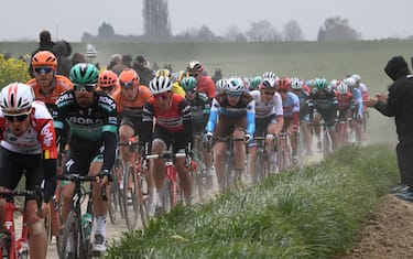 TOPSHOT - The pack rides on the Vertain to Saint-Martin-sur-Ecaillon cobbled stones sector (24) during the 117th edition of the Paris-Roubaix one-day classic cycling race, between Compiegne and Roubaix, near Vertain, northern France on April 14, 2019. (Photo by Anne-Christine POUJOULAT / AFP)        (Photo credit should read ANNE-CHRISTINE POUJOULAT/AFP via Getty Images)