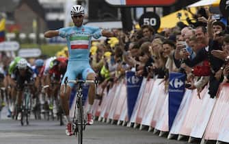 451764246 Italy's Vincenzo Nibali celebrates as he crosses the finish line at the end of the 201 km second stage of the 101st edition of the Tour de France cycling race on July 6, 2014 between York and Sheffield, northern England. AFP PHOTO / ERIC FEFERBERG (Photo credit should read ERIC FEFERBERG/AFP via Getty Images)