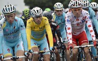 451962094 (From L) Netherlands' Lieuwe Westra, Italy's Vincenzo Nibali wearing the overall leader's yellow jersey and France's Cyril Lemoine wearing the best climber's polka dot jersey take the start of the 194 km sixth stage of the 101st edition of the Tour de France cycling race on July 10, 2014 between Arras and Reims, northern France. AFP PHOTO / JEFF PACHOUD (Photo credit should read JEFF PACHOUD/AFP via Getty Images)