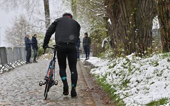 Illustration picture shows snow as a cyclist walks up the Koppenberg with his bike by the hand, during a training session on the track of the Ronde van Vlaanderen cycling race, Friday 01 April 2022. The 106th edition of the cycling race will take place on Easter Sunday 03 April. BELGA PHOTO DIRK WAEM (Photo by DIRK WAEM/Belga/Sipa USA)