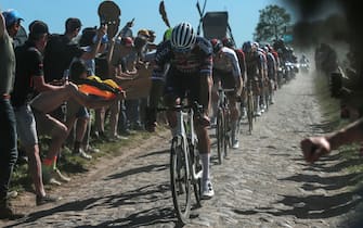 epa09894619 Alpecin Fenix team rider Mathieu Van Der Poel of the Netherlands cycles over a cobblestone sector during the Paris - Roubaix cycling race in Compiegne, France, 17 April 2022.  EPA/CHRISTOPHE PETIT TESSON