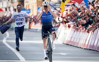 A climate protester follows Belgian Remco Evenepoel of Quick-Step Alpha Vinyl, who celebrates as he crosses the finish line to win the Liege-Bastogne-Liege one day cycling race, 257,5km from Liege to Liege, Sunday 24 April 2022, in Liege. BELGA PHOTO BENOIT DOPPAGNE (Photo by BENOIT DOPPAGNE/Belga/Sipa USA)