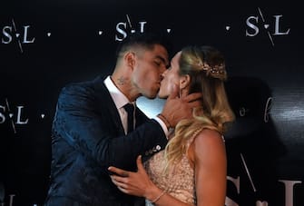 TOPSHOT - Uruguayan Barcelona forward Luis Suarez kisses his wife Sofia Balbi upon their arrival at a party for the renewal of their marriage vows in La Barra, near Punta del Este, Uruguay, on December 26, 2019. (Photo by EITAN ABRAMOVICH / AFP) (Photo by EITAN ABRAMOVICH/AFP via Getty Images)
