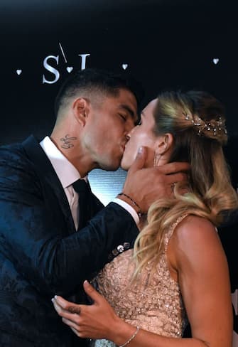 Uruguayan Barcelona forward Luis Suarez kisses his wife Sofia Balbi upon their arrival at a party for the renewal of their marriage vows in La Barra, near Punta del Este, Uruguay, on December 26, 2019. (Photo by EITAN ABRAMOVICH / AFP) (Photo by EITAN ABRAMOVICH/AFP via Getty Images)