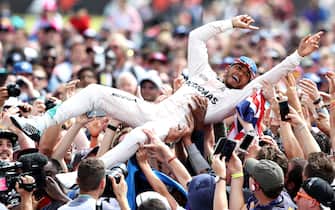 NORTHAMPTON, ENGLAND - JULY 10:  Lewis Hamilton of Great Britain and Mercedes GP crowd surfs with the fans to celebrate his win during the Formula One Grand Prix of Great Britain at Silverstone on July 10, 2016 in Northampton, England.  (Photo by Mark Thompson/Getty Images)