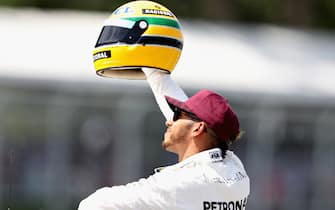 MONTREAL, QC - JUNE 10:  Pole sitter Lewis Hamilton of Great Britain and Mercedes GP with a commemorative helmet of F1 legend Ayrton Senna after he beat the previous record of 65 pole positions during qualifying for the Canadian Formula One Grand Prix at Circuit Gilles Villeneuve on June 10, 2017 in Montreal, Canada.  (Photo by Mark Thompson/Getty Images)