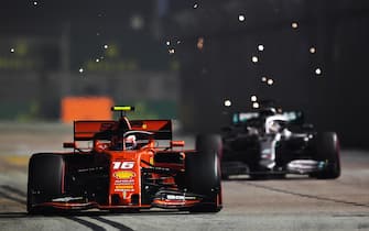 SINGAPORE, SINGAPORE - SEPTEMBER 22: Charles Leclerc of Monaco driving the (16) Scuderia Ferrari SF90 leads Lewis Hamilton of Great Britain driving the (44) Mercedes AMG Petronas F1 Team Mercedes W10 on track during the F1 Grand Prix of Singapore at Marina Bay Street Circuit on September 22, 2019 in Singapore. (Photo by Clive Mason/Getty Images)