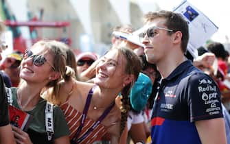 ABU DHABI, UNITED ARAB EMIRATES - NOVEMBER 30: Daniil Kvyat of Russia and Scuderia Toro Rosso poses for a photo with fans before final practice for the F1 Grand Prix of Abu Dhabi at Yas Marina Circuit on November 30, 2019 in Abu Dhabi, United Arab Emirates. (Photo by Peter Fox/Getty Images)
