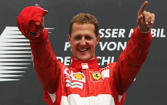 Hockenheim, GERMANY:  German Ferrari driver Michael Schumacher celebrates on the podium of the Hockenheim racetrack after the German Grand Prix, 30 July 2006, in Hockenheim. German Ferrari driver Michael Schumacher won the race ahead of team mate Brazilian Felipe Massa and Finnish McLaren-Mercedes driver Kimi Raikkonen.  AFP PHOTO PATRIK STOLLARZ  (Photo credit should read PATRIK STOLLARZ/AFP via Getty Images)