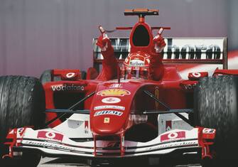 Michael Schumacher of Germany driving the #1 Scuderia Ferrari Marlboro Ferrari F2004 Ferrari V10 with his arms raised from the cockpit celebrates winning the Formula One Spanish Grand Prix on 9 May 2004  at the Circuit de Barcelona-Catalunya, Barcelona , Spain.  (Photo by Darren Heath/Getty Images)  